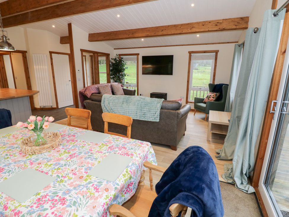 A living room with a dining table and chairs at Cedar Lodge in Rugeley
