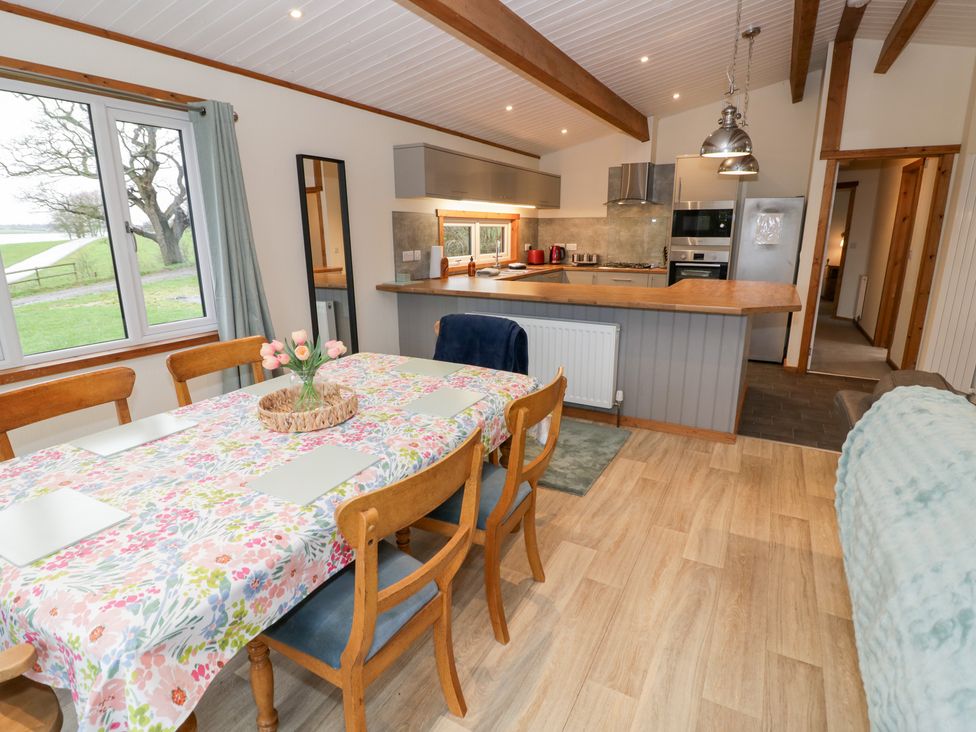 A dining area with a table and chairs at Cedar Lodge in Rugeley