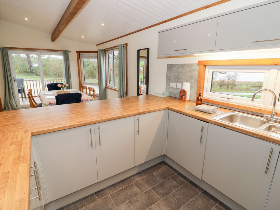 A kitchen with a counter and sink at Cedar Lodge in Rugeley
