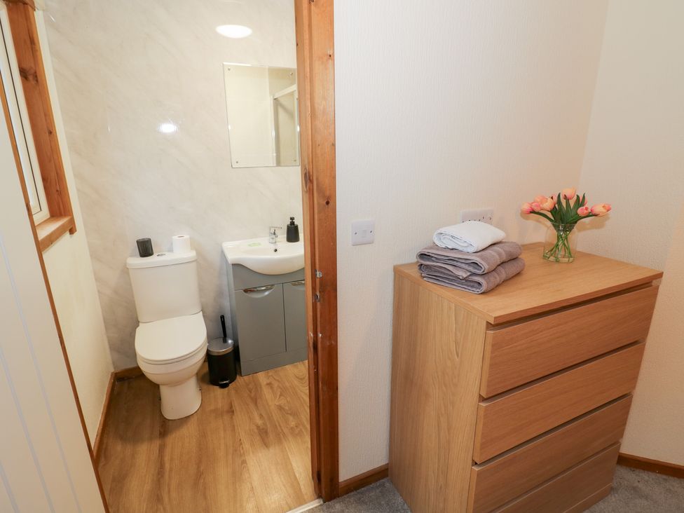 A bathroom with a toilet and sink at Cedar Lodge in Rugeley