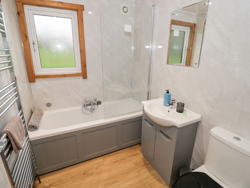A bathroom with a bathtub and shower at Cedar Lodge in Rugeley