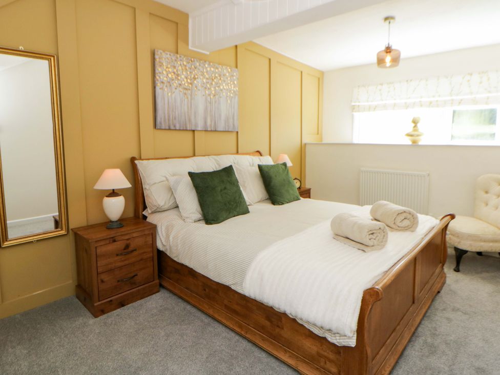 A bedroom with a bed and nightstand at Shearers in Llandysul