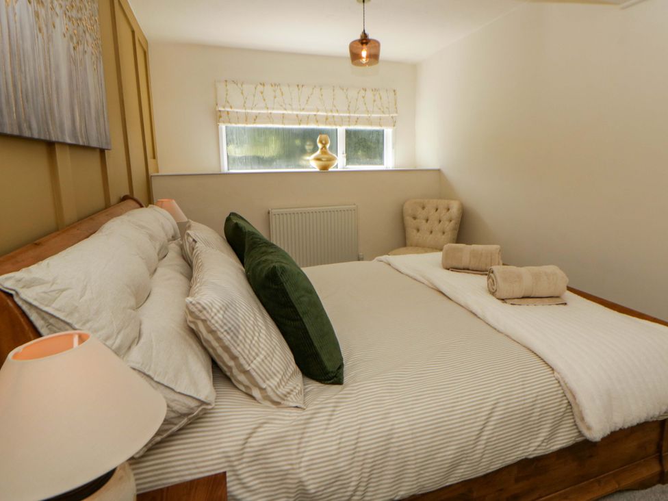 A bedroom with a bed and window at Shearers in Llandysul