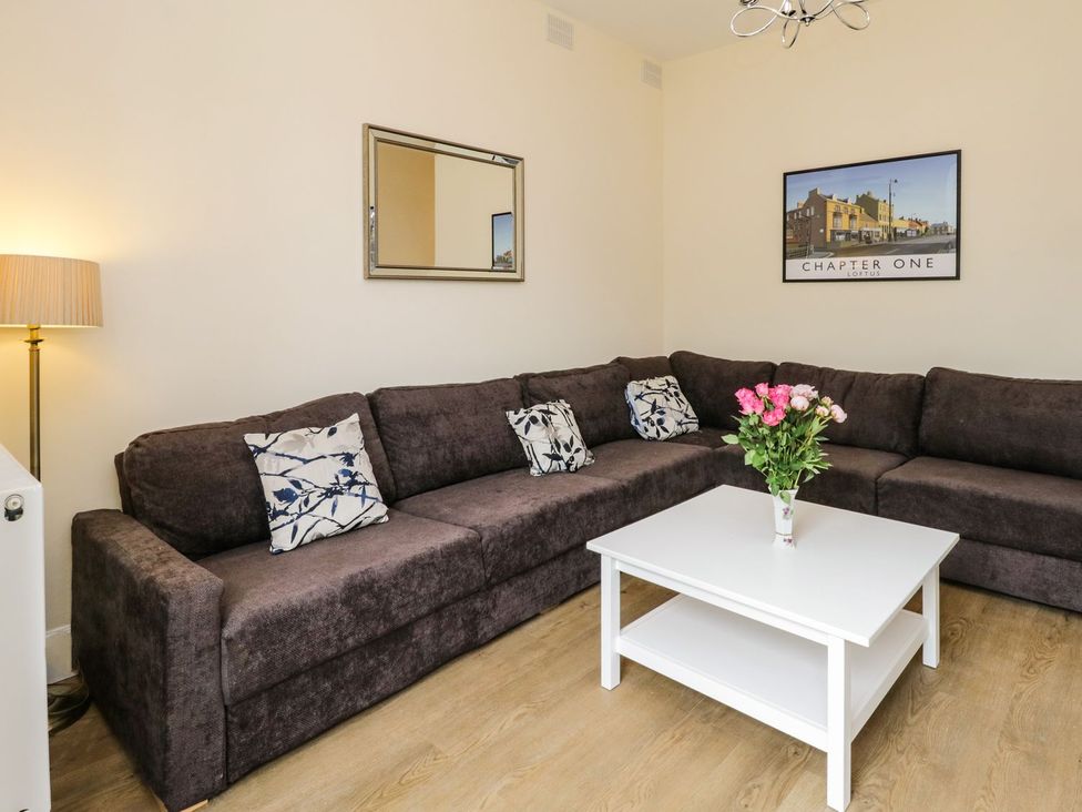A living room with a sofa and coffee table at The Kesi Residence Loftus