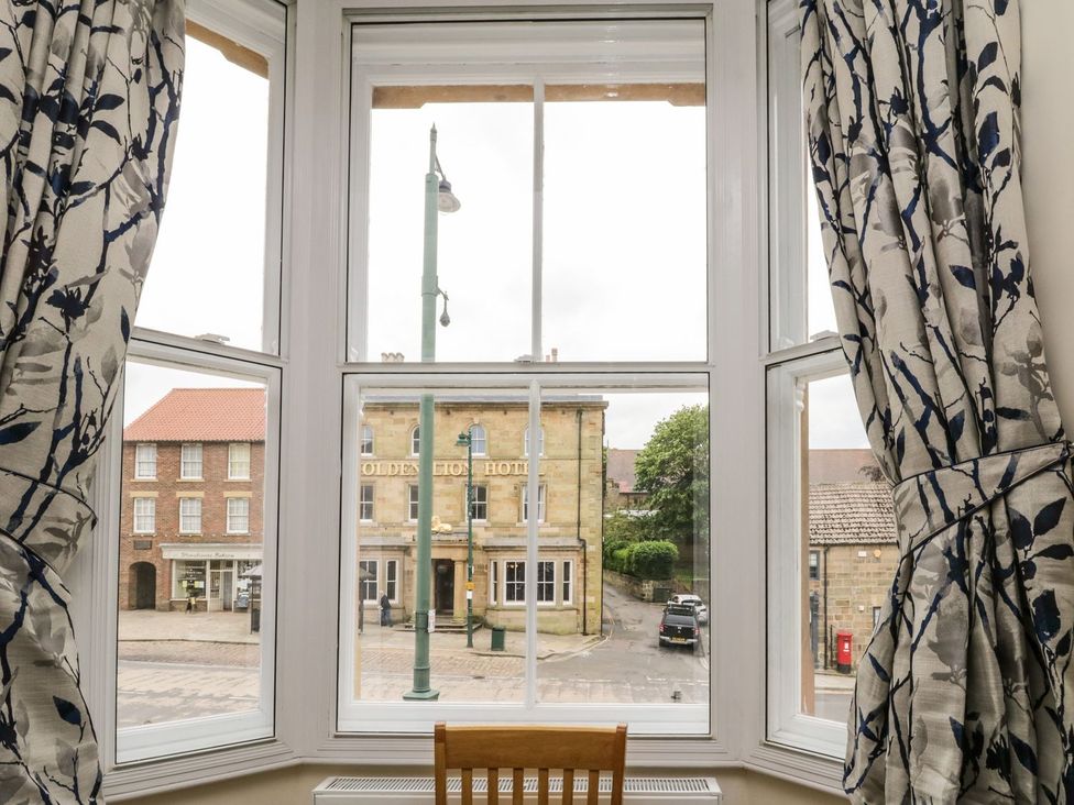 A living room with a view of the Olde Lion Hotel at The Kesi Residence in Loftus