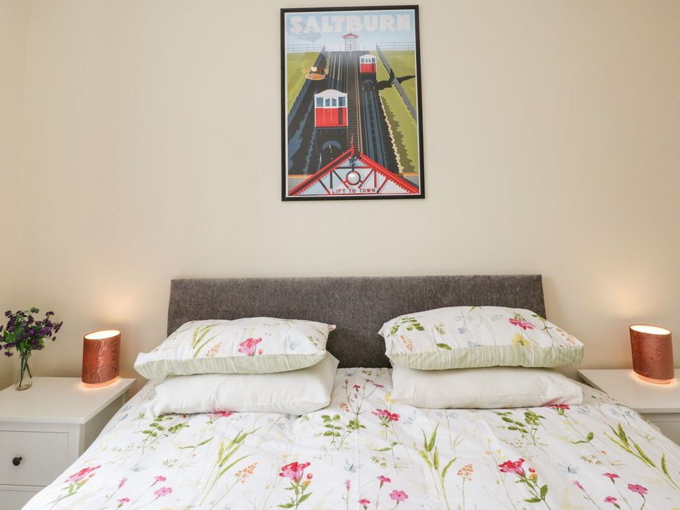 A bedroom with a bed and bedside table at The Kesi Residence in Loftus