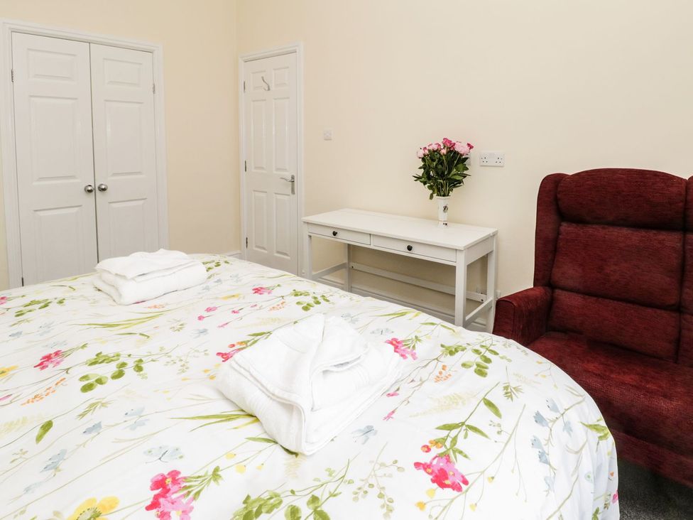 A bedroom with a bed and a chair at The Kesi Residence in Loftus