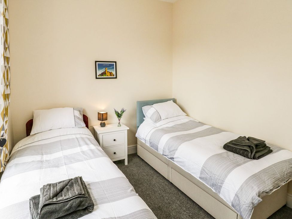 A bedroom with two beds and a nightstand at The Kesi Residence in Loftus