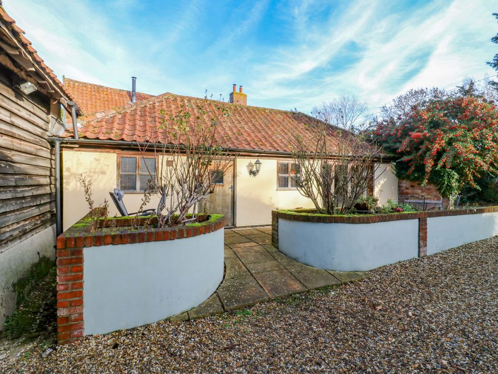A garden entrance with a pathway and plants at The Old Cow Shed in 