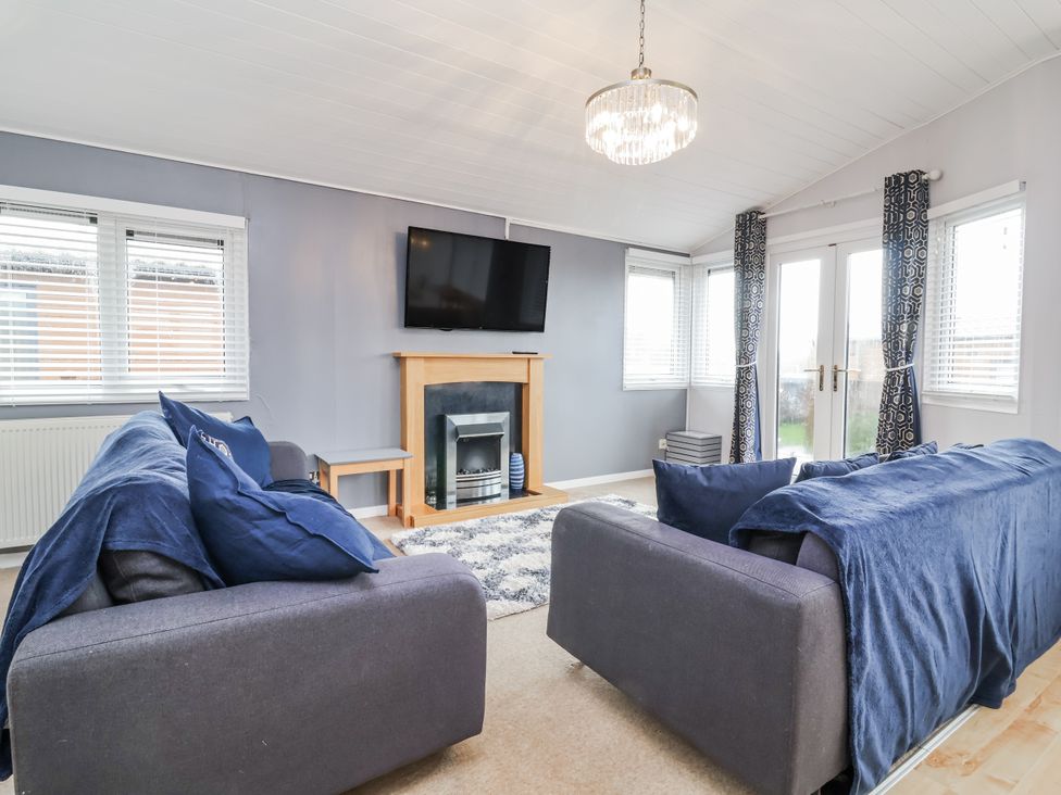A living room with a television and fireplace at Ocean View Ilfracombe