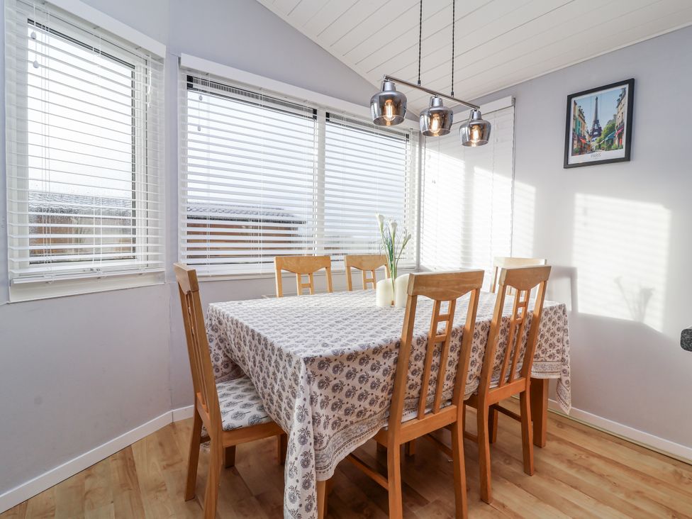 A dining room with a table and chairs at Ocean View, Ilfracombe