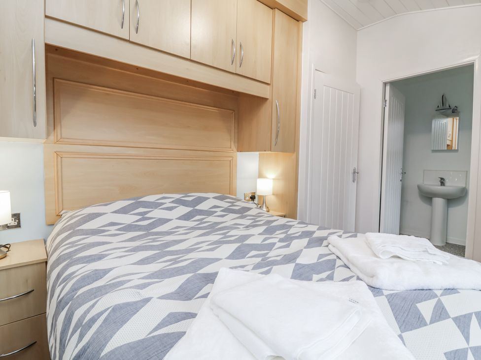 A bedroom with a bed and wardrobe at Ocean View in Ilfracombe