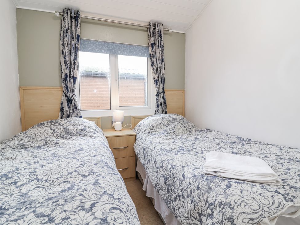 A bedroom with two beds and a window at Ocean View in Ilfracombe