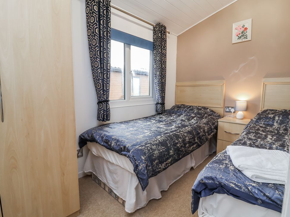 A bedroom with two beds and a window at Ocean View in Ilfracombe
