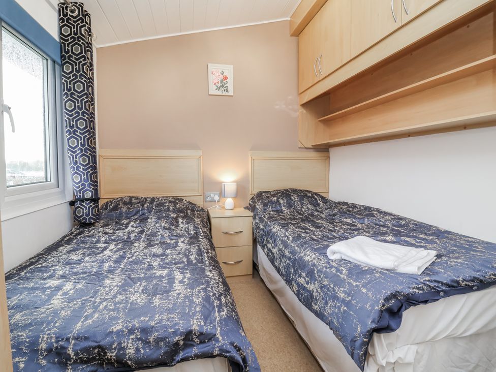 A bedroom with two single beds and a window at Ocean View in Ilfracombe