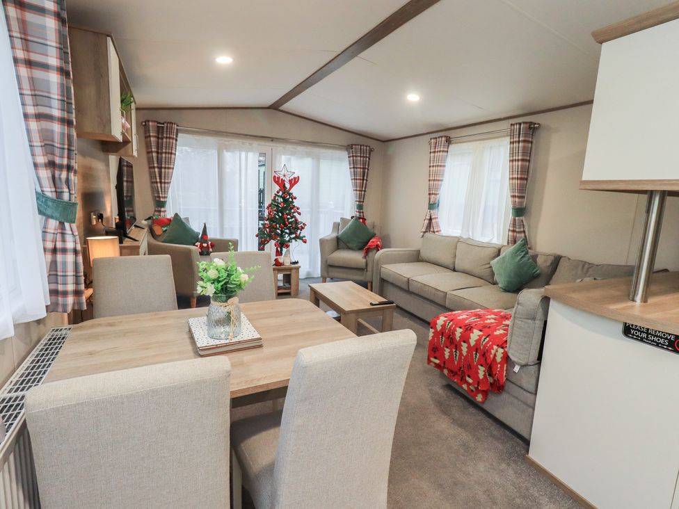 A living room with a sofa and dining area at Caravan