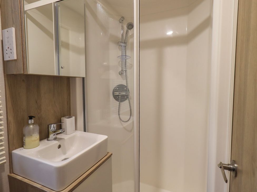 A shower and sink area in a bathroom at Caravan