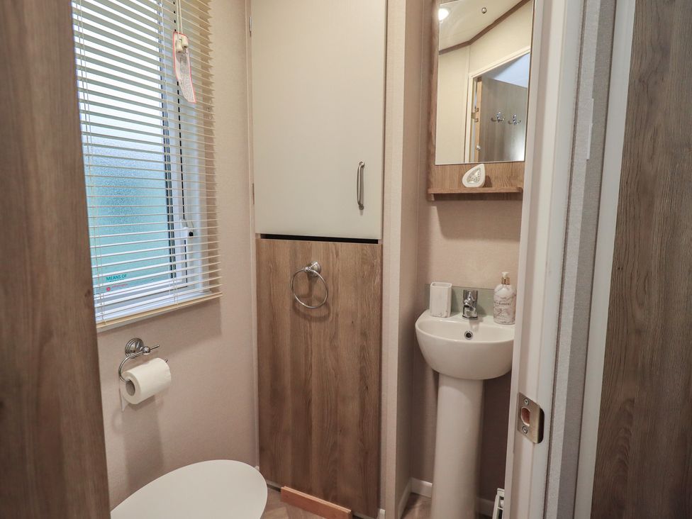 A bathroom with a sink and toilet at Caravan