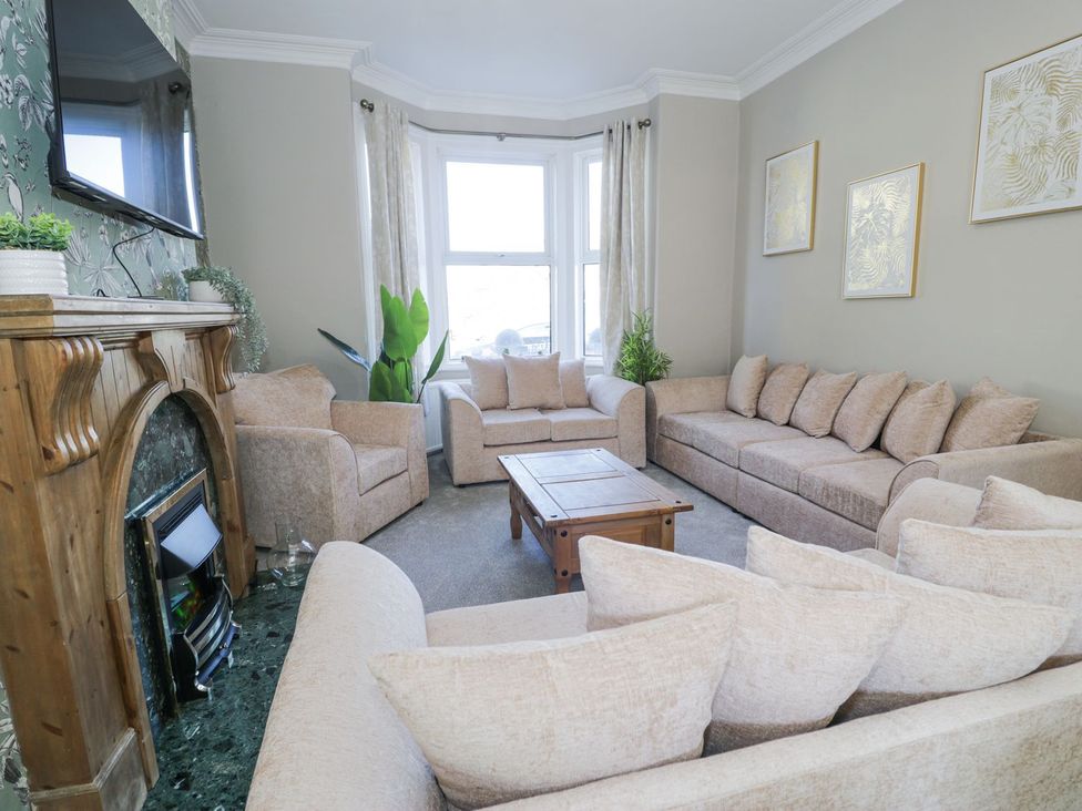 A living room with a sofa and coffee table at Canning Lodge in Colwyn Bay
