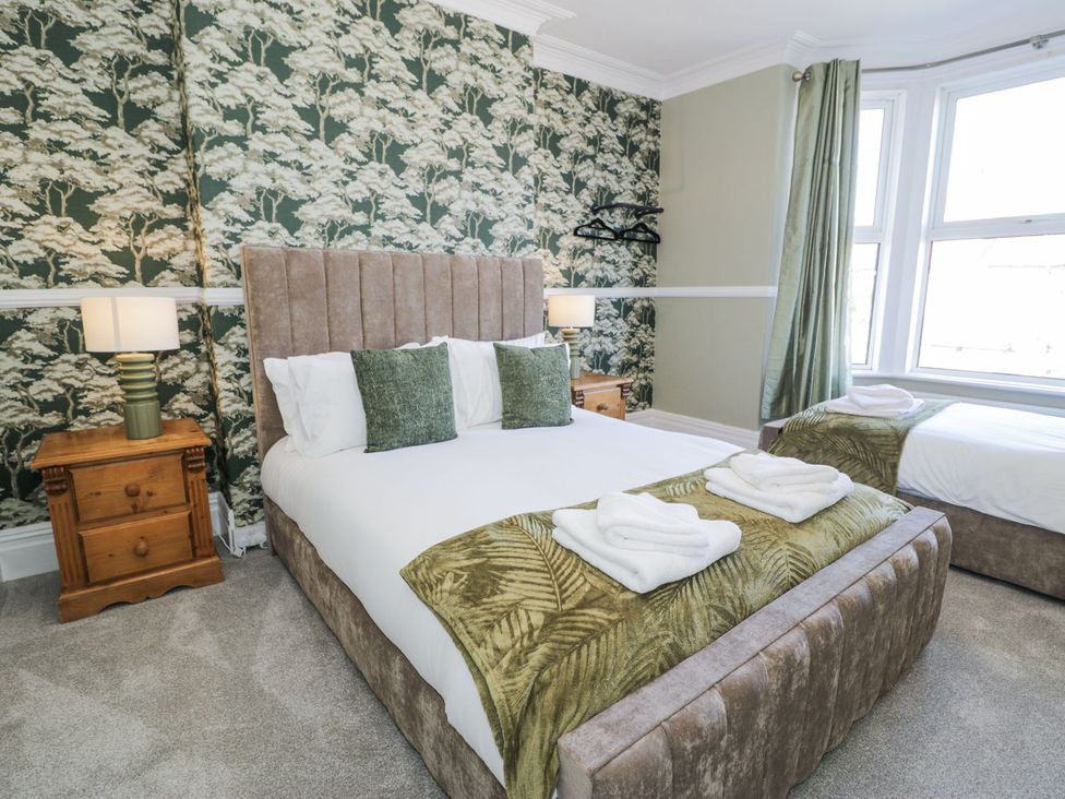 A bedroom with a bed and bedside table at Canning Lodge in Colwyn Bay