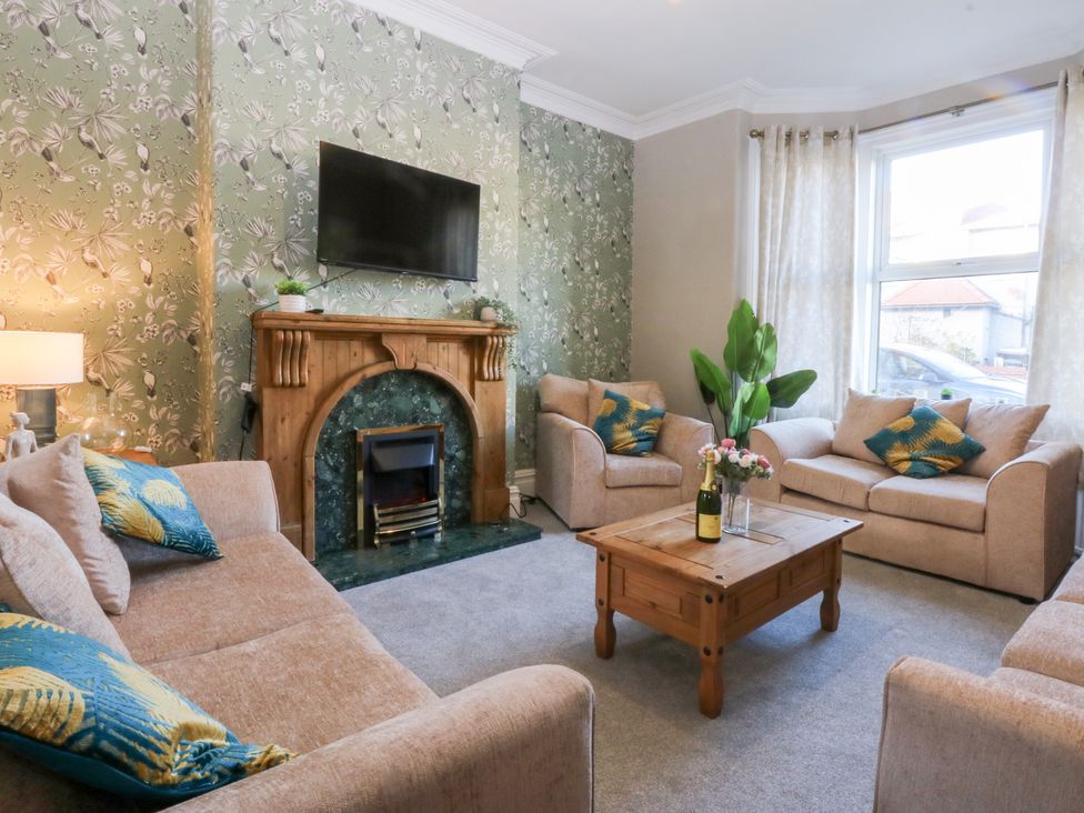 A living room with a coffee table and sofas at Canning Lodge in Colwyn Bay