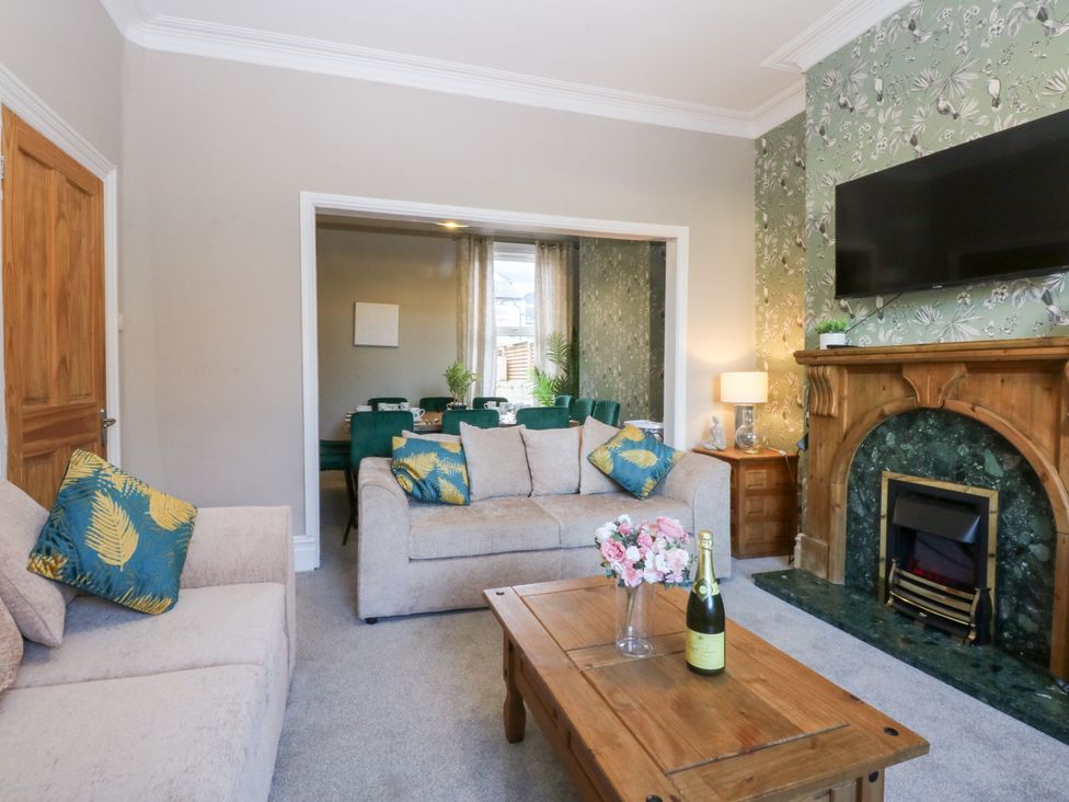 A living room with a sofa and coffee table at Canning Lodge in Colwyn Bay