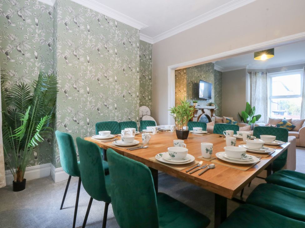 A dining room with a table set for tea at Canning Lodge Colwyn Bay