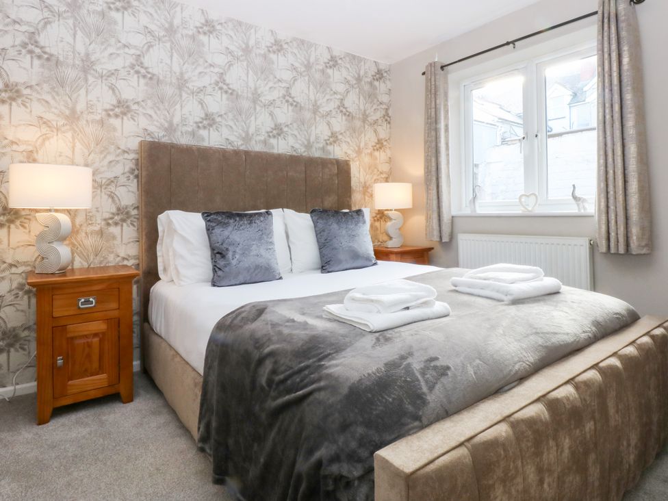 A bedroom with a bed and bedside table at Canning Lodge in Colwyn Bay