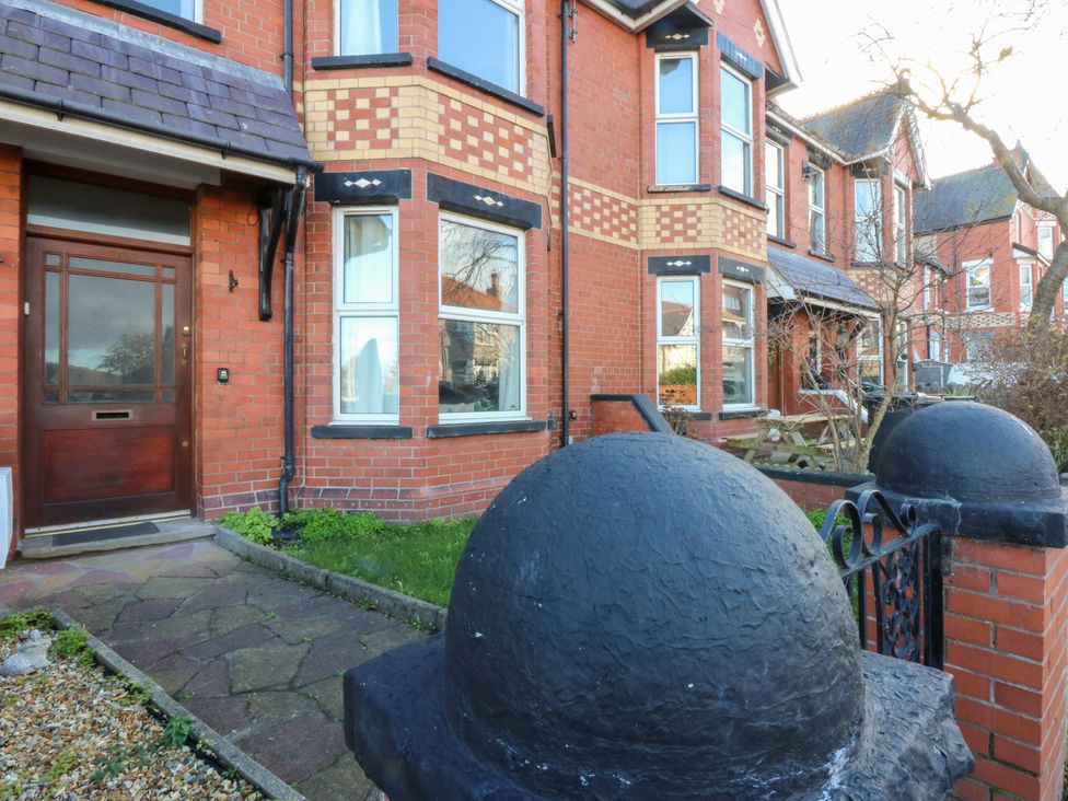 A house entrance with a front door and windows at Canning Lodge in Colwyn Bay
