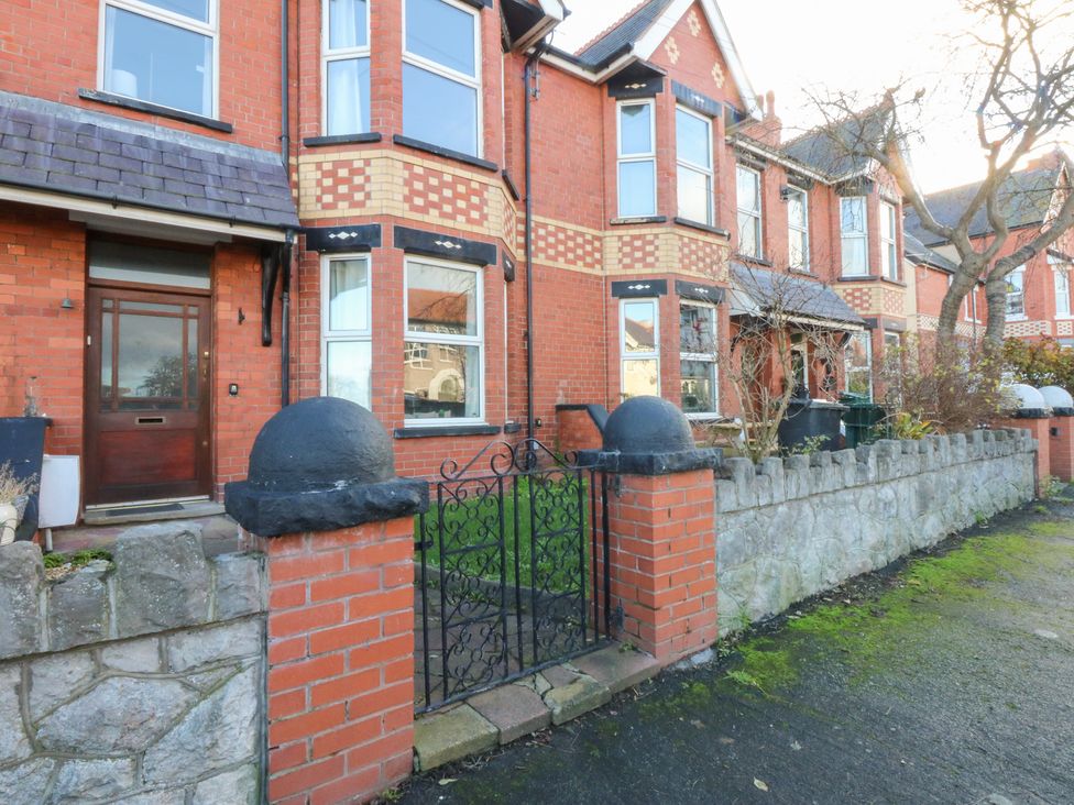 A house with a front door and garden at Canning Lodge in Colwyn Bay