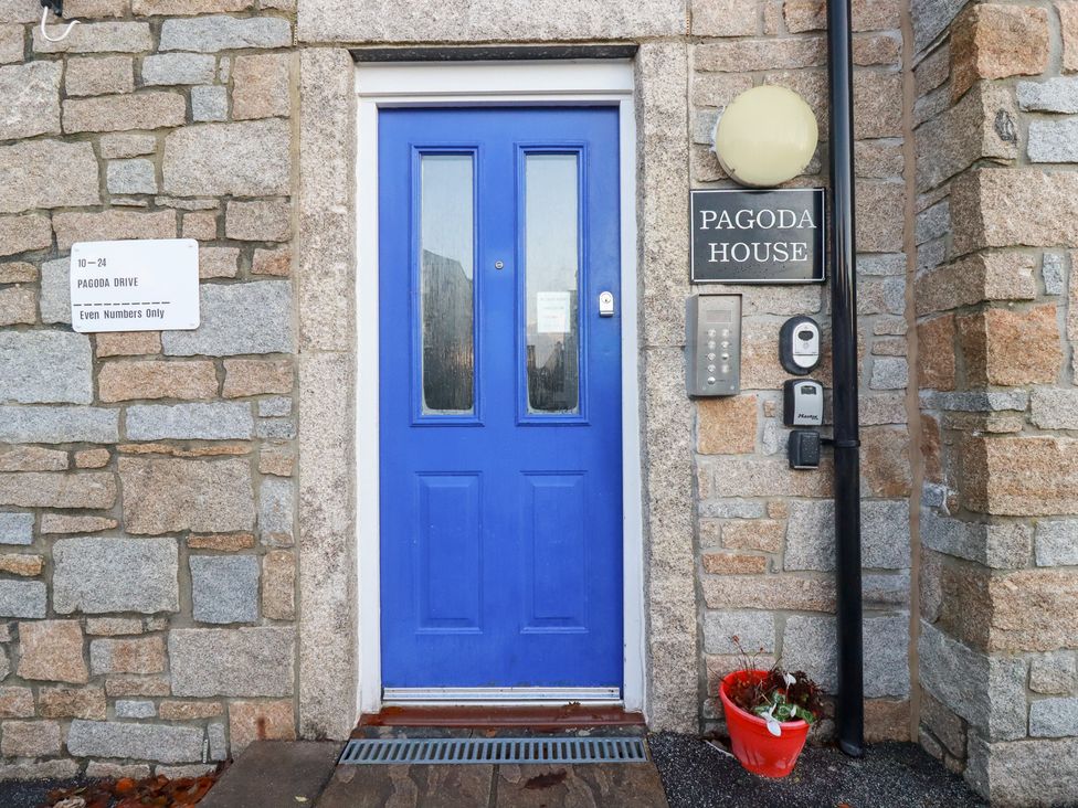 An entrance with a blue door and sign at Pagoda House in St. Austell