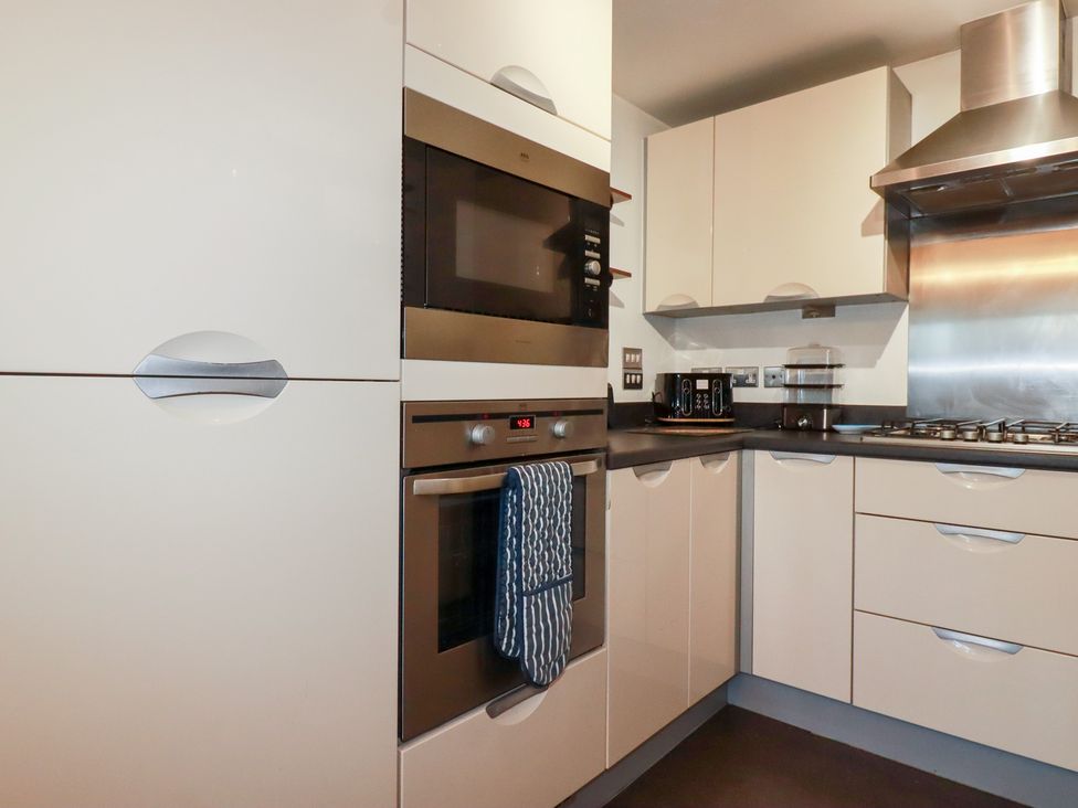 A kitchen with appliances and cabinetry at 18 Pagoda Drive in St. Austell