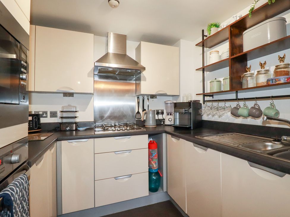 A kitchen with cabinets, gas stove, and coffee machine at 18 Pagoda Drive, St. Austell