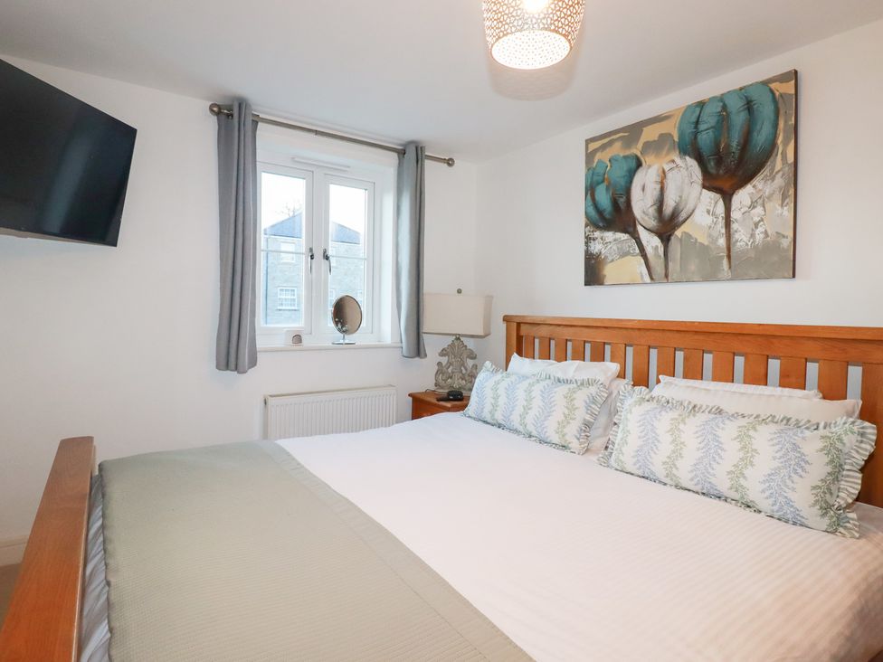 A bedroom with a bed and television at 18 Pagoda Drive St. Austell