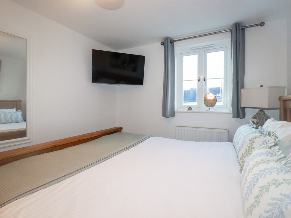 A bedroom with a bed and television at 18 Pagoda Drive St. Austell