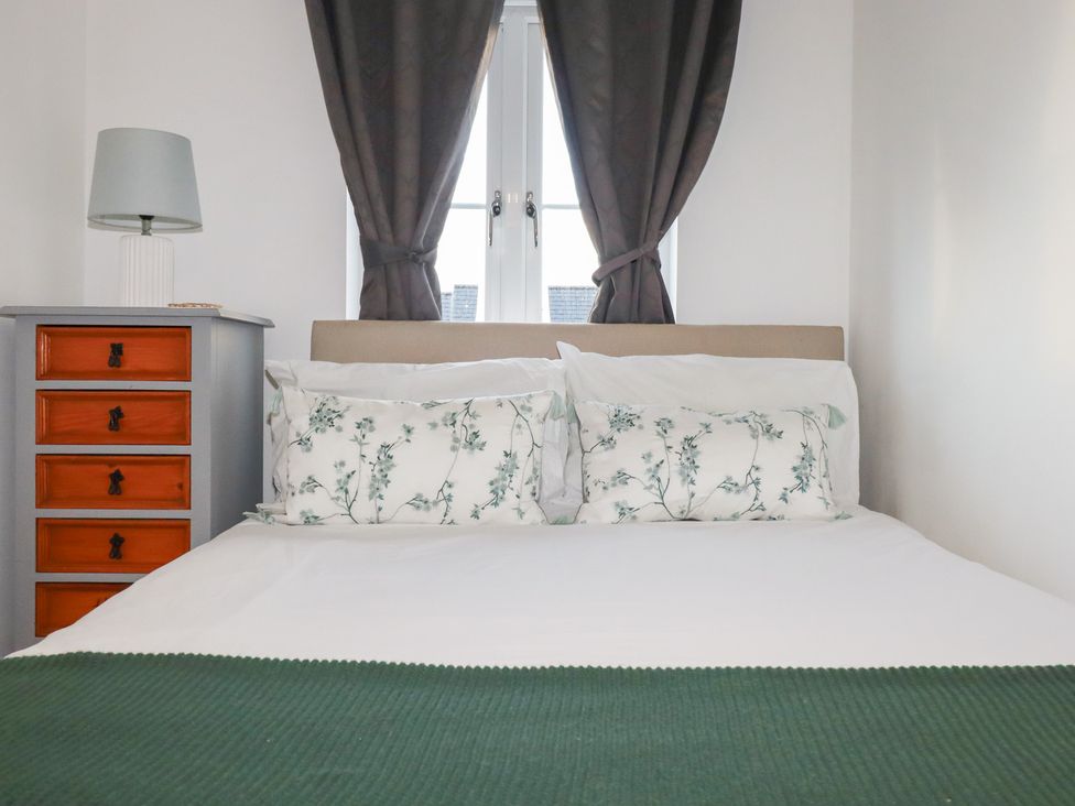 A bedroom with a bed and a drawer unit at 18 Pagoda Drive St. Austell