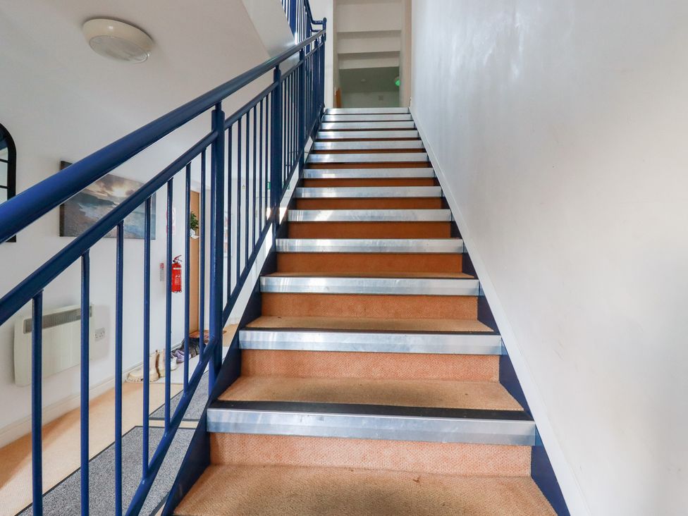 A staircase with metal and carpeted steps at 18 Pagoda Drive St. Austell
