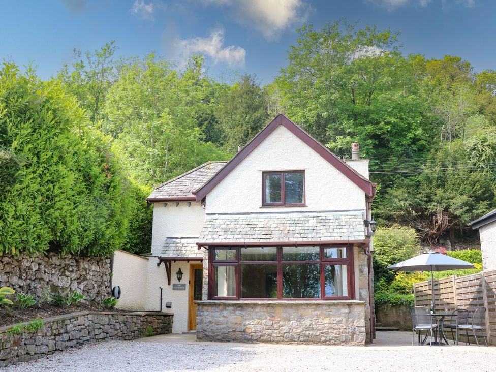 A house with a patio and umbrella at The Coach House Carnforth