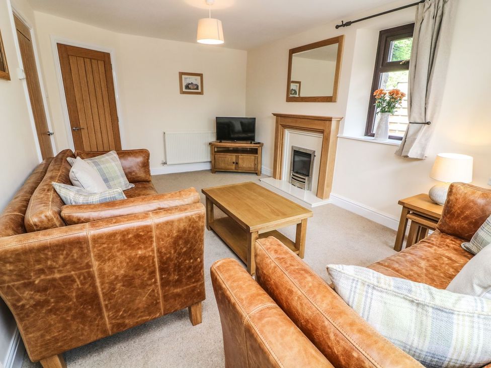 A living room with sofas and a coffee table at The Coach House in Carnforth
