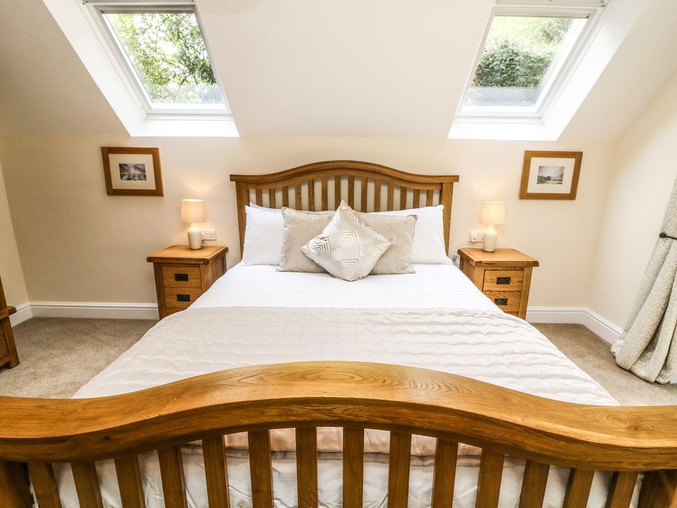 A bedroom with a bed and bedside tables at The Coach House in Carnforth