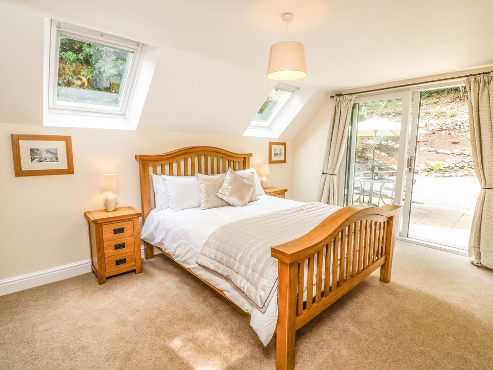 A bedroom with a bed and bedside table at The Coach House in Carnforth