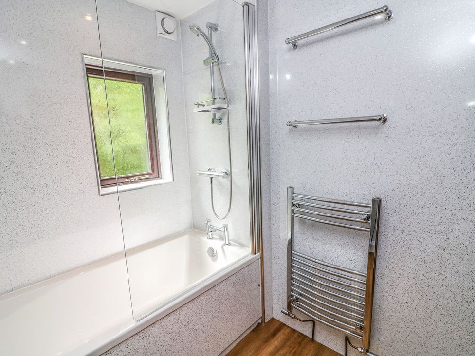 A bathroom with a shower and bathtub at The Coach House in Carnforth