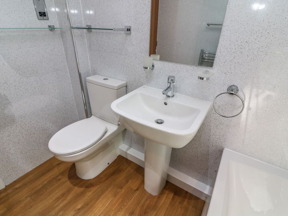 A bathroom with a toilet and sink at The Coach House in Carnforth