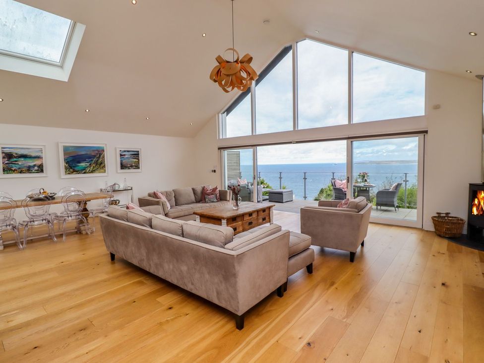 A living room with a sofa and dining table at 2 Remera St. Ives