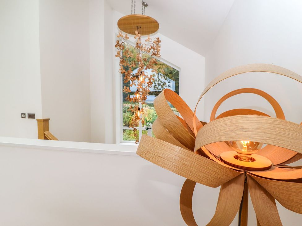 A chandelier and window in a hallway at 2 Remera St. Ives