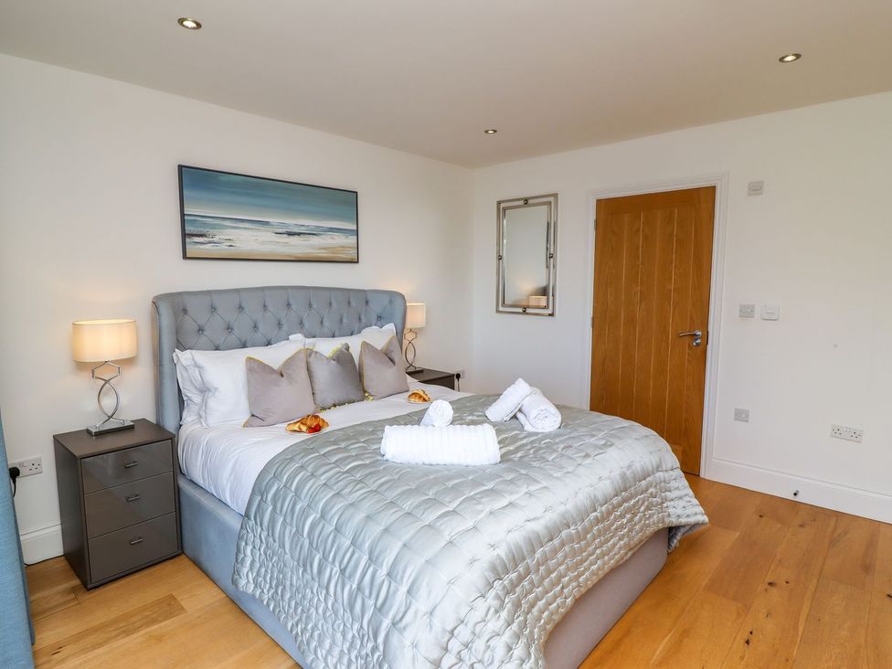 A bedroom with a bed and bedside table at 2 Remera in St. Ives
