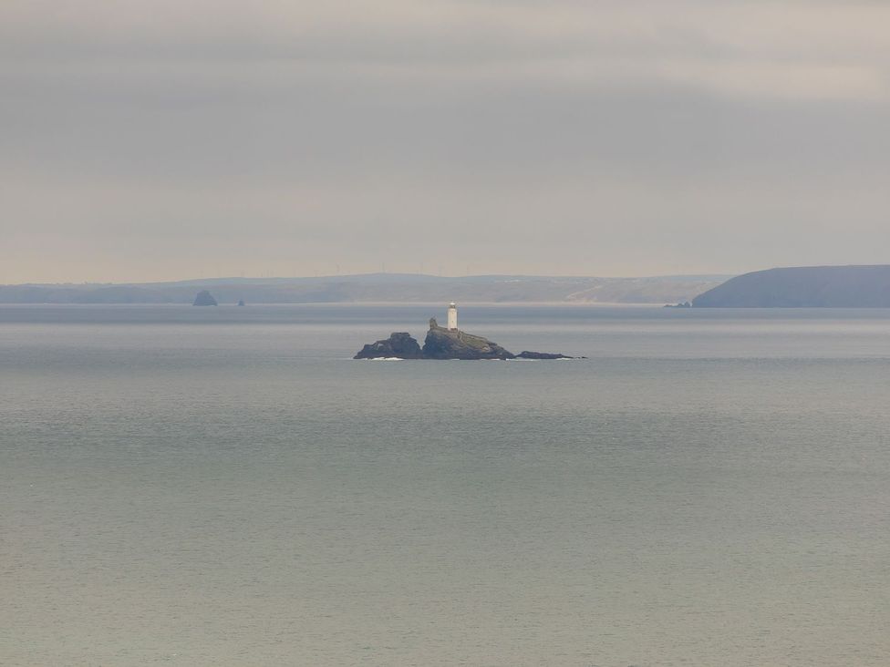 A lighthouse on an island in the ocean at 2 Remera St. Ives