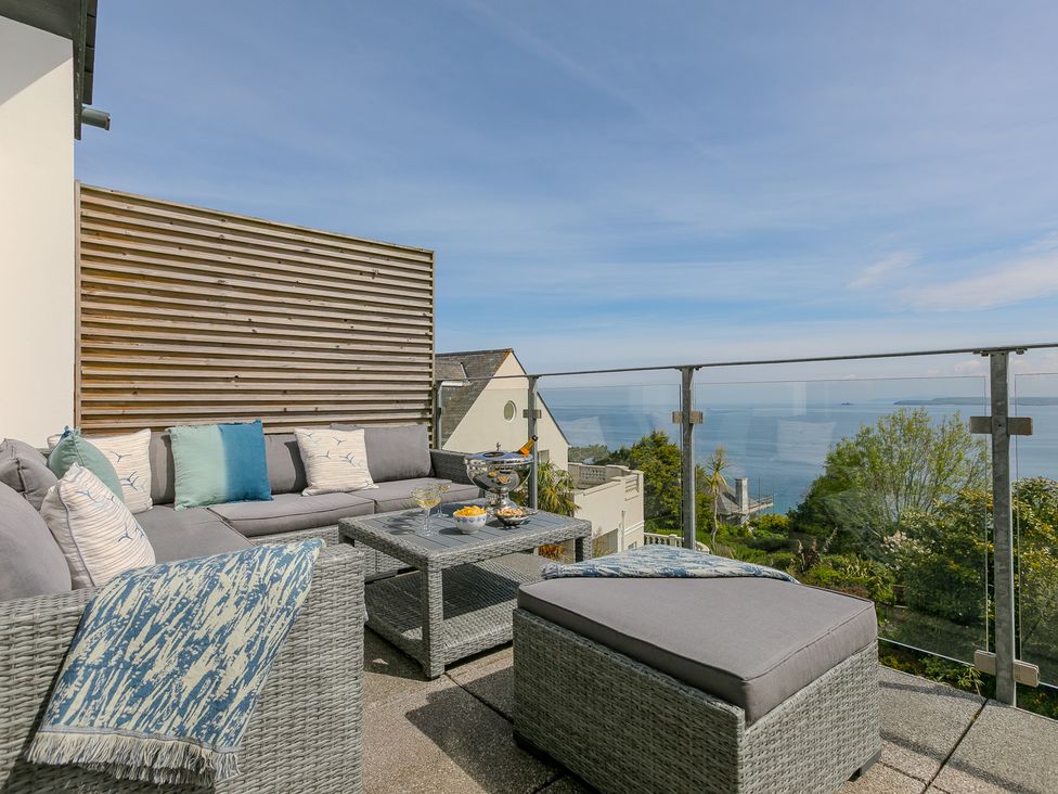 An outdoor seating area with a sofa and coffee table at 2 Remera St Ives