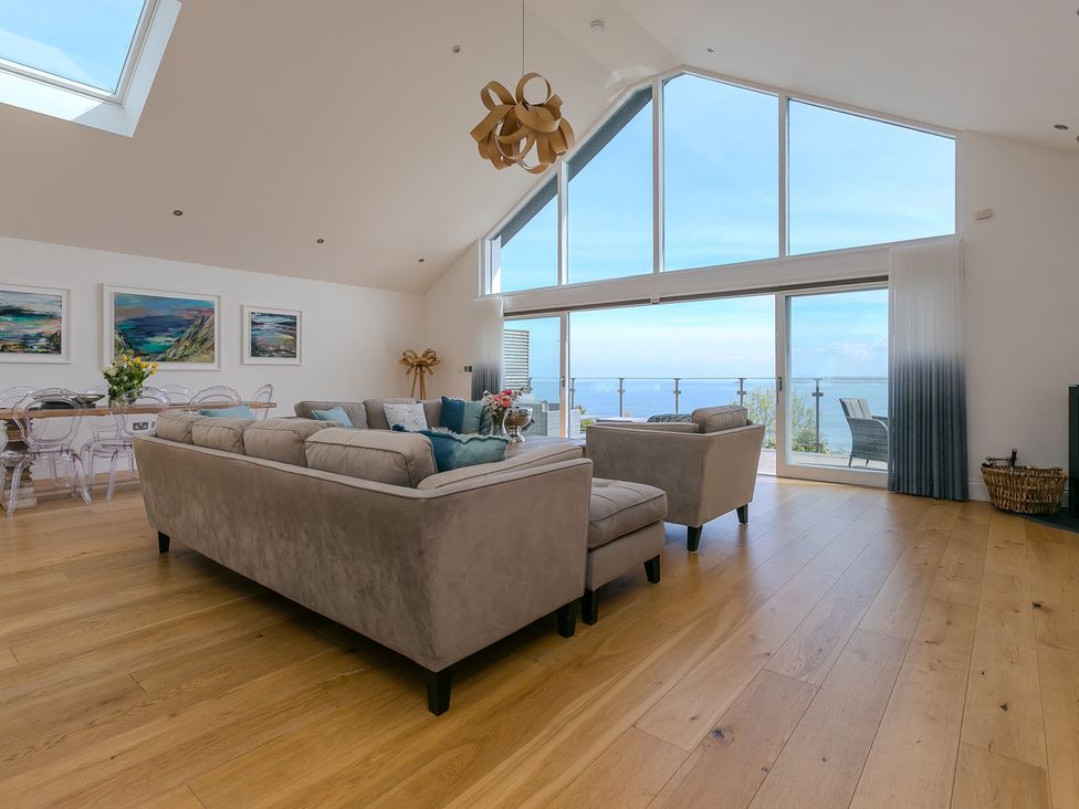 A living room with a sofa and table at 2 Remera in St Ives