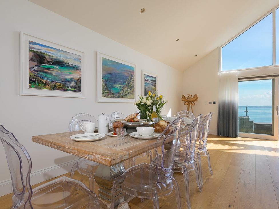 A dining room with a table set for meals at 2 Remera St Ives